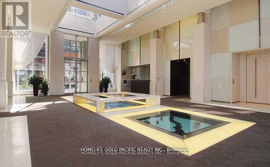 A living room with a glass table and a television.