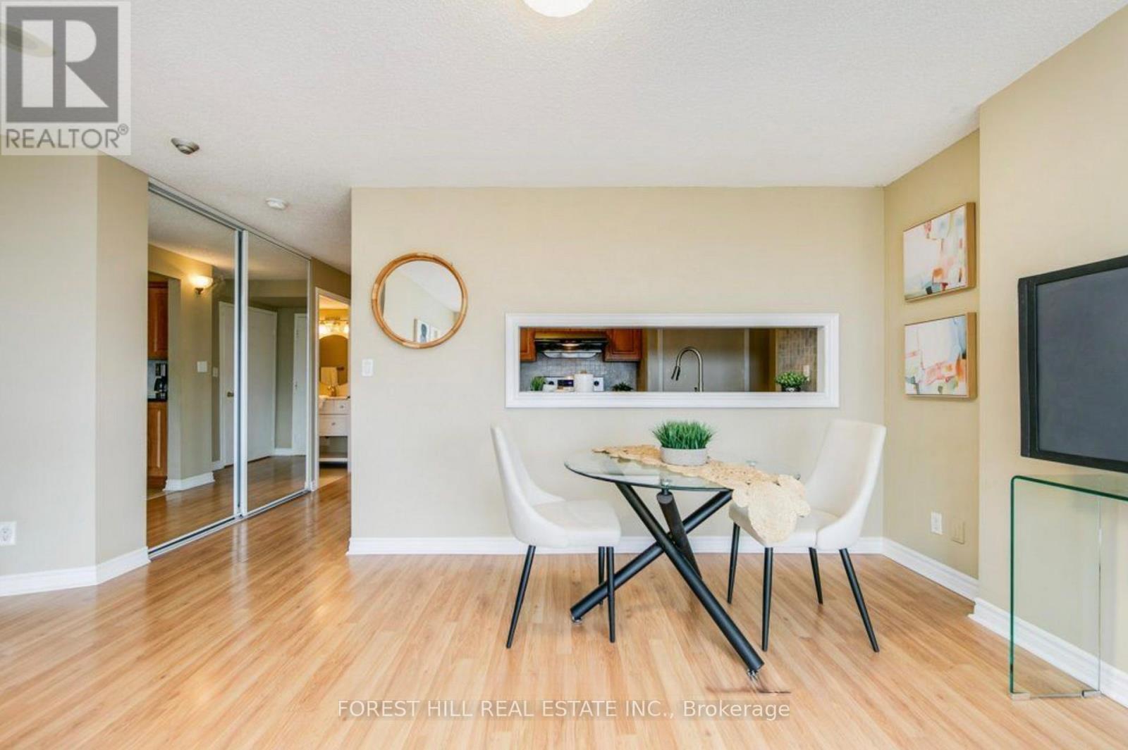 A dining room with a table and chairs.