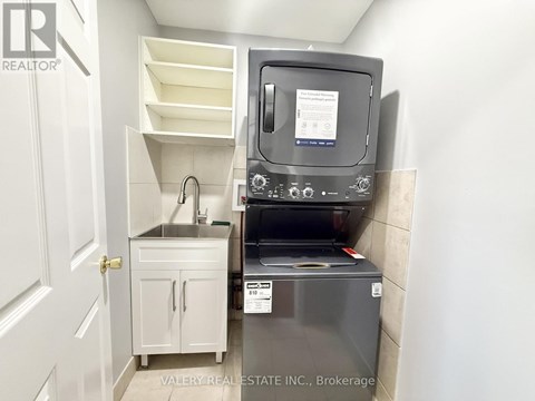 A small kitchen with a sink and a microwave.