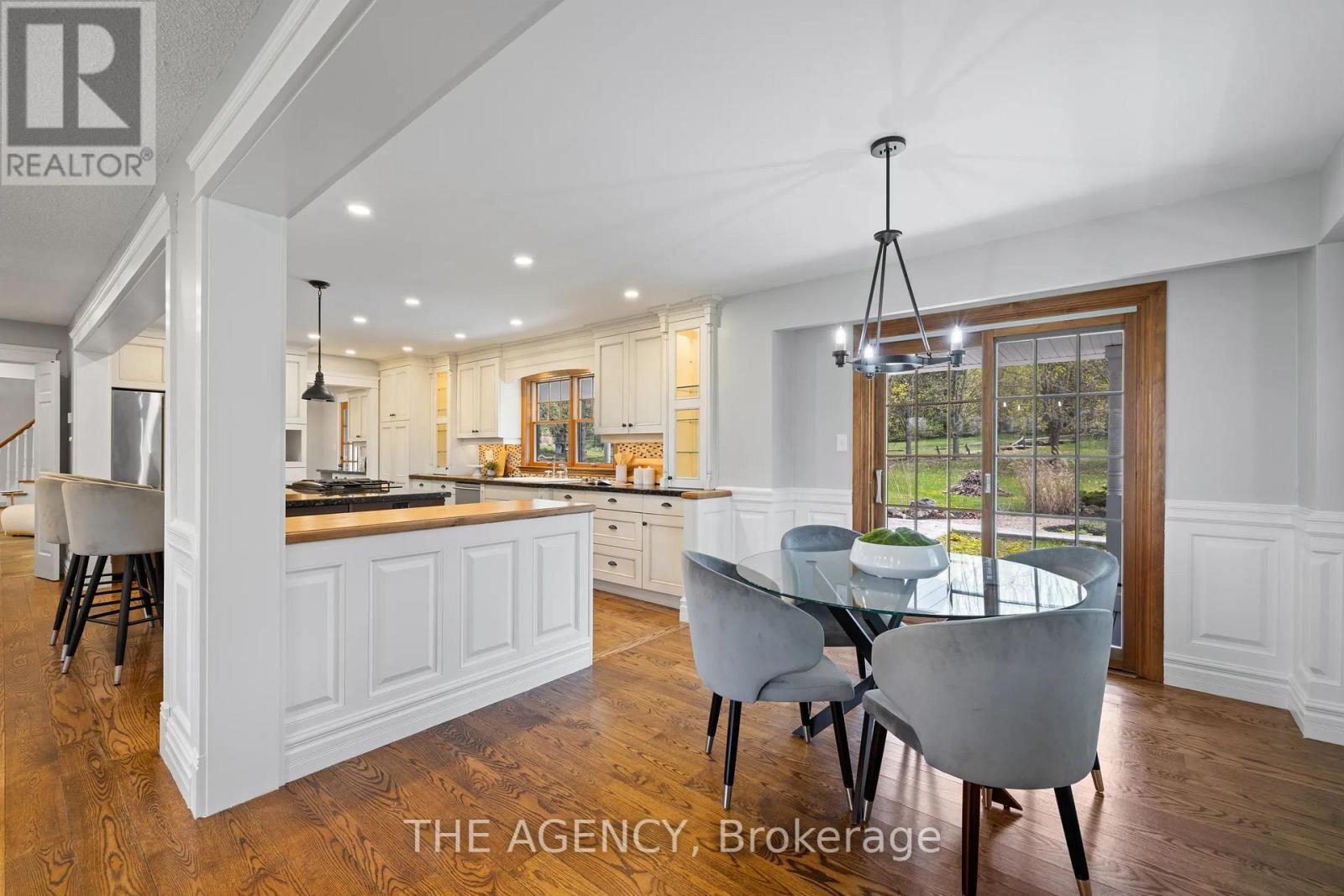 A modern kitchen with a dining table and chairs.