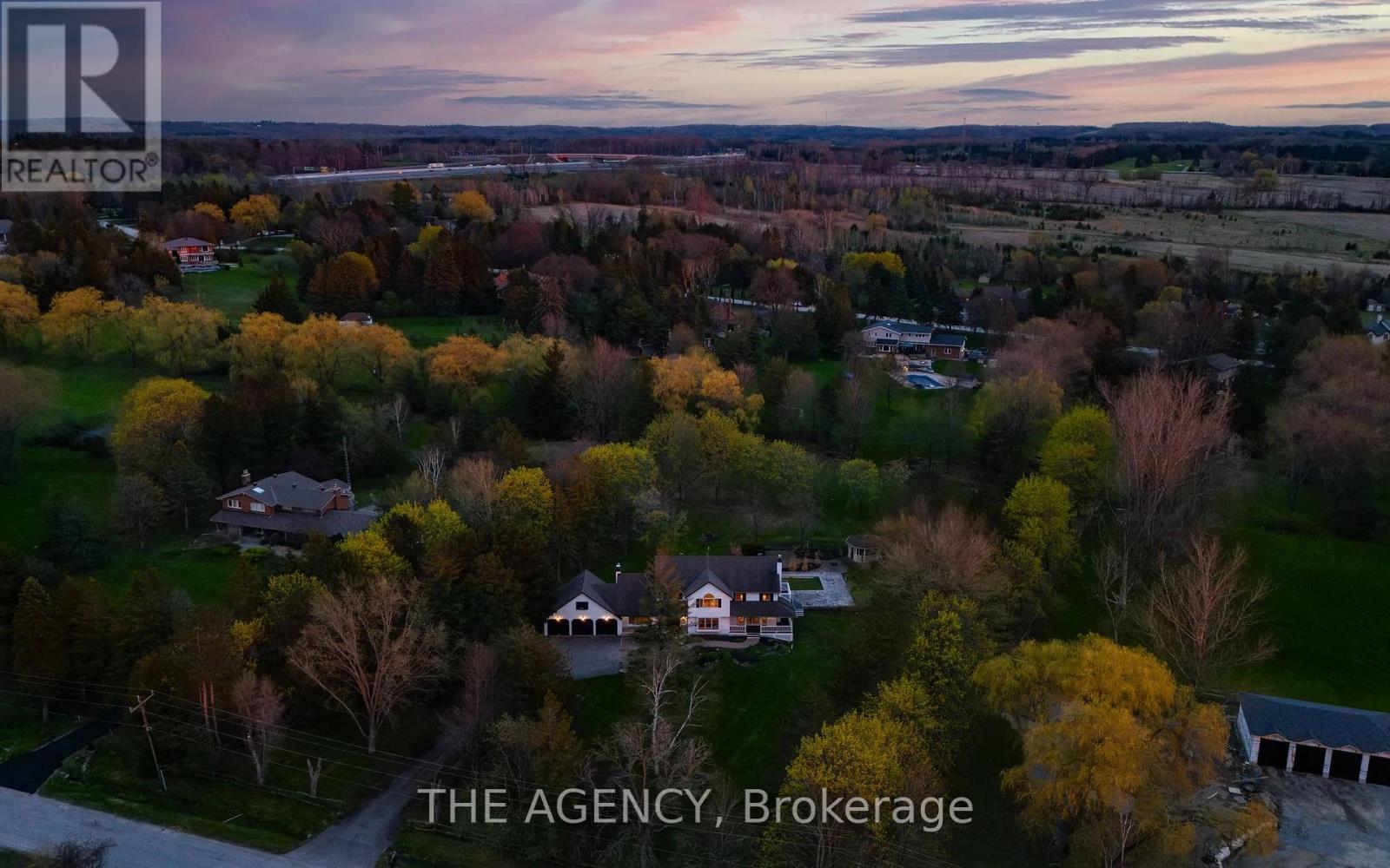 An aerial view of a residential area with houses and trees.