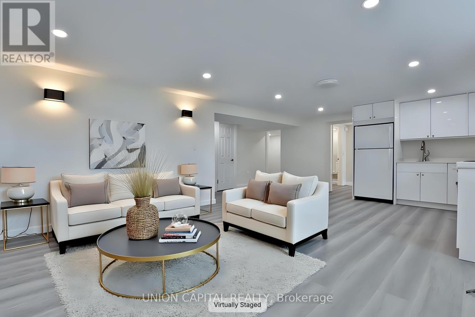 A modern living room with a coffee table in the center.