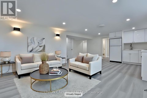 A modern living room with a coffee table in the center.