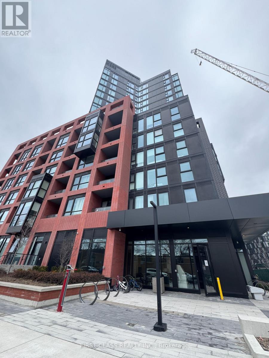 A modern building with a glass facade and a red brick exterior.