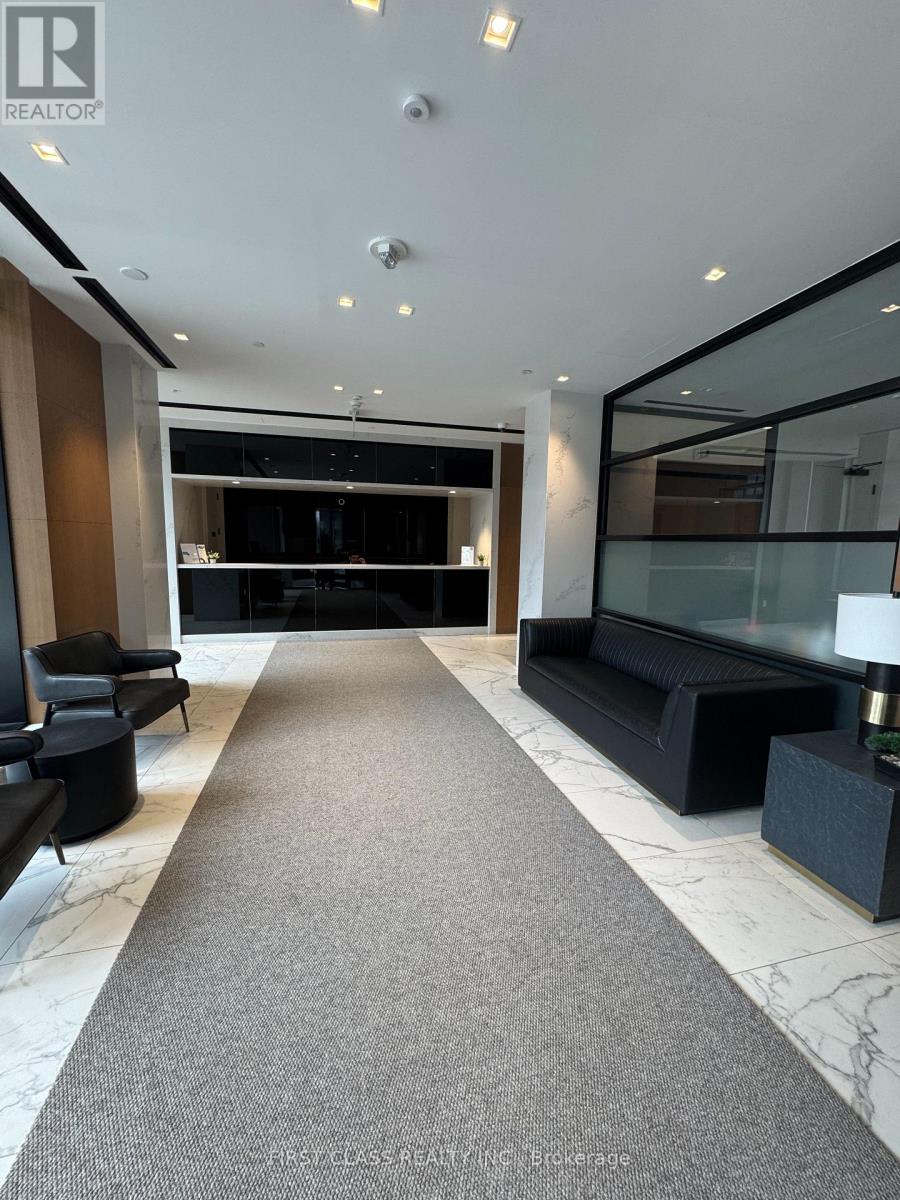 A spacious lobby with a carpeted floor and a glass wall.