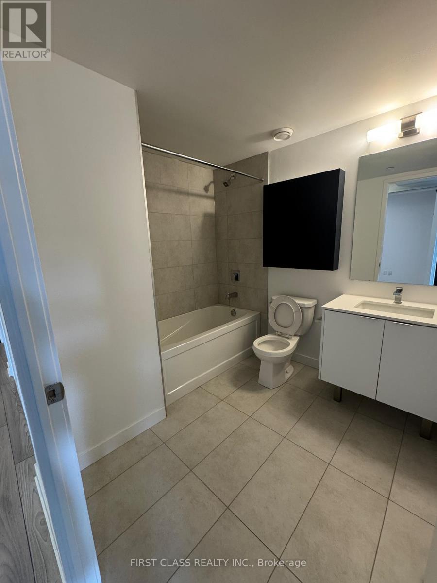 A bathroom with a toilet, sink, and bathtub.