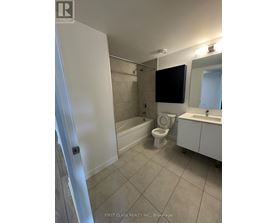 A bathroom with a toilet, sink, and bathtub.