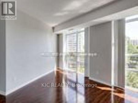 A room with a sliding glass door leading to a balcony.