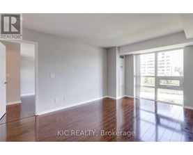 A room with a sliding glass door leading to a balcony.