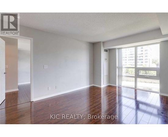A room with a sliding glass door leading to a balcony.