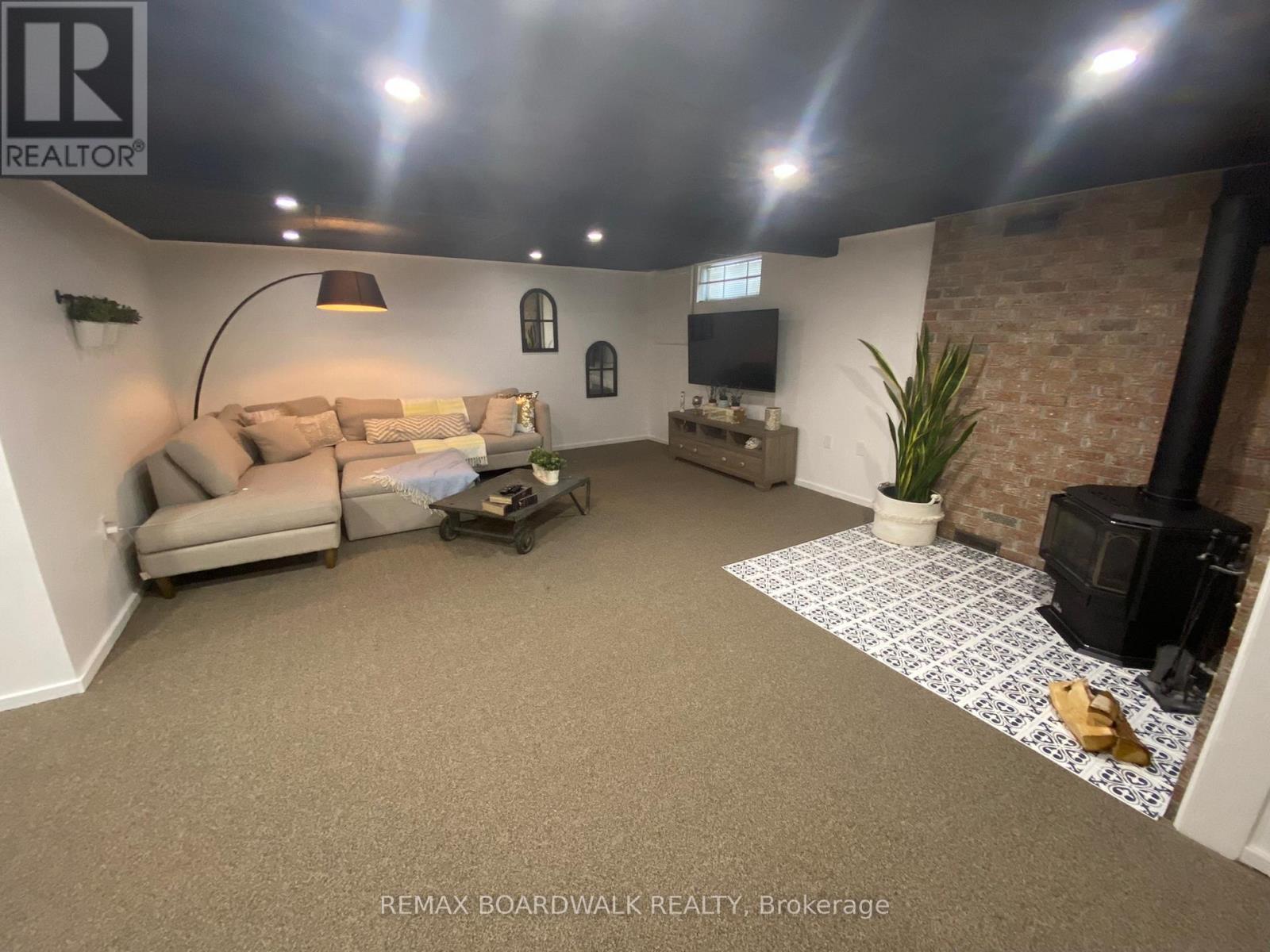 A living room with a couch, coffee table, and a flat screen TV.