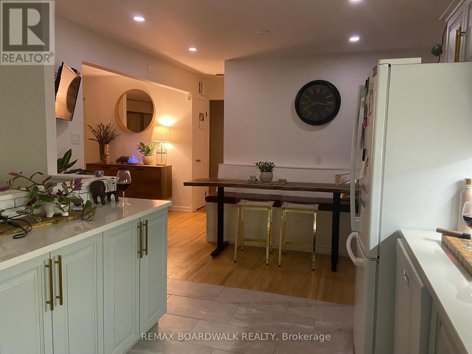 A kitchen with a refrigerator on the right side.