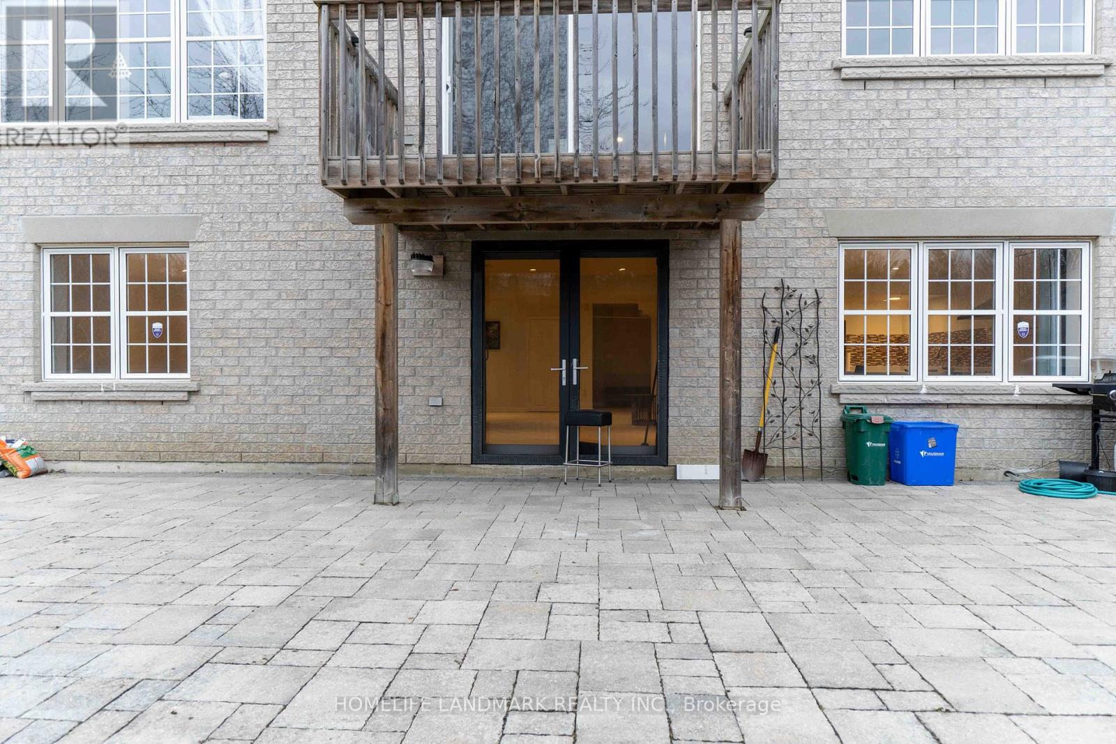 A balcony with a railing is on the second floor of a building.