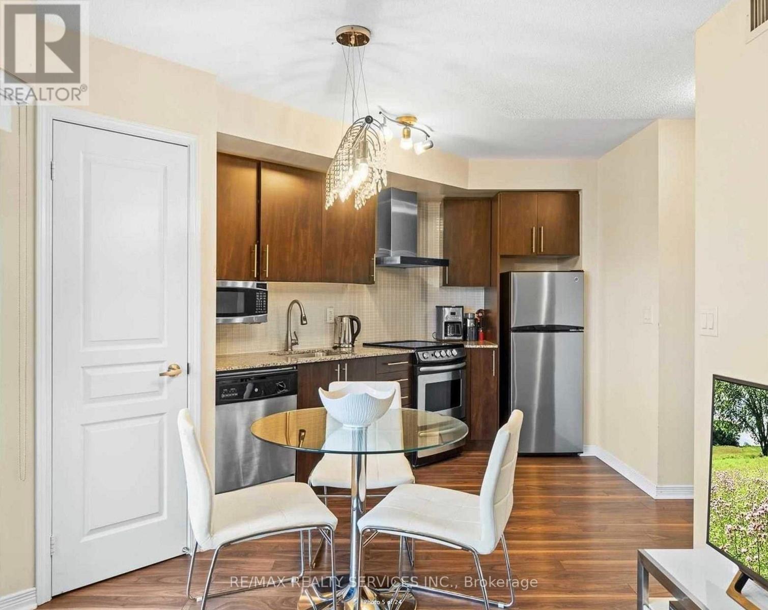 A kitchen with a table and chairs in the middle of it.