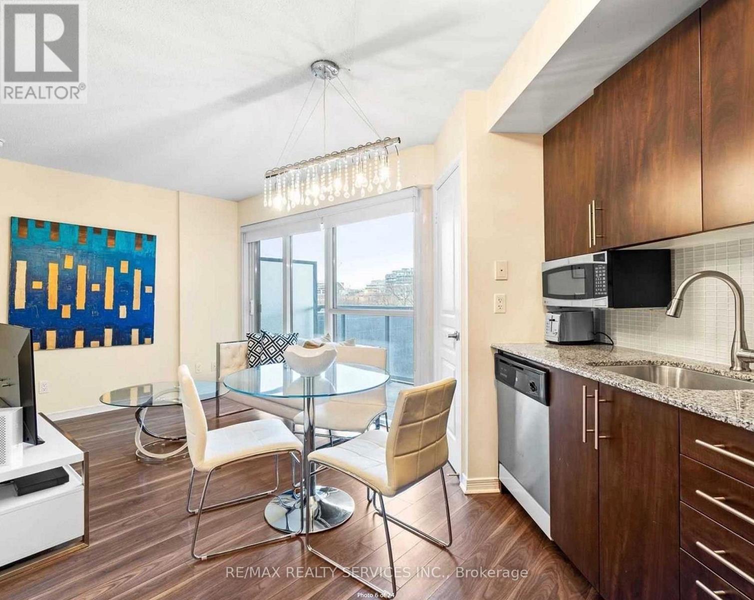 A modern kitchen with a glass table and chairs.