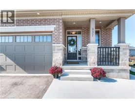 A house with a black front door and a garage door.
