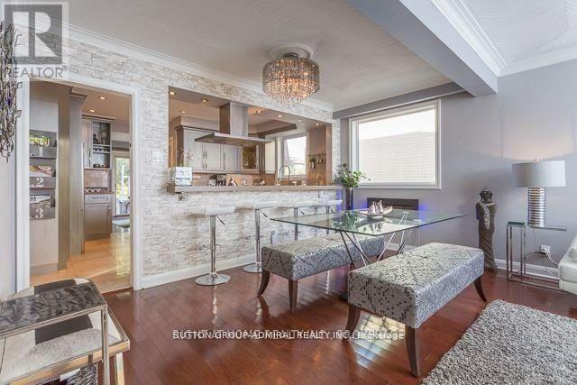 A modern kitchen with a breakfast bar and a dining area.