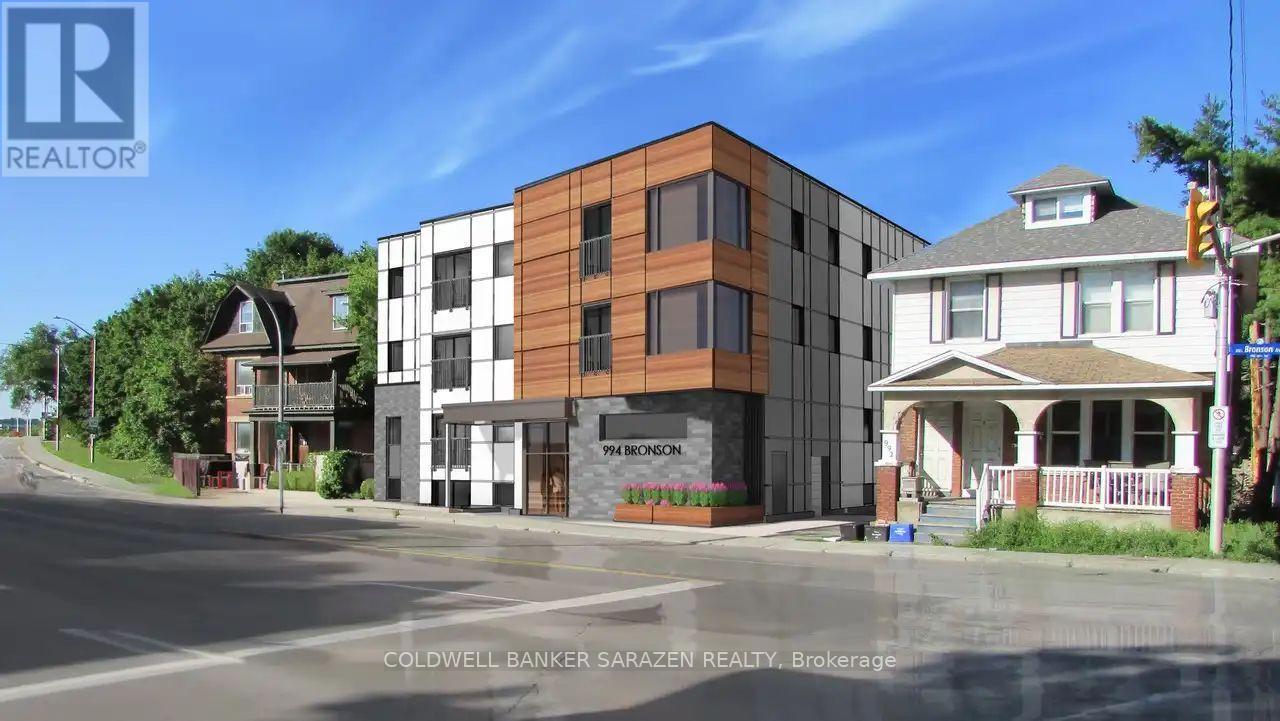 A street view of a building with the sign "Coldwell Banker SaraZen Realty Brokerage" in front of it.