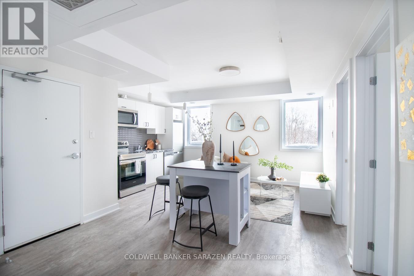 A modern kitchen with white cabinets and a dining table with chairs.