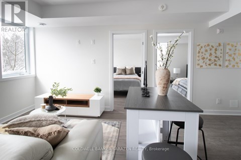 A modern living room with a white couch and a wooden coffee table.