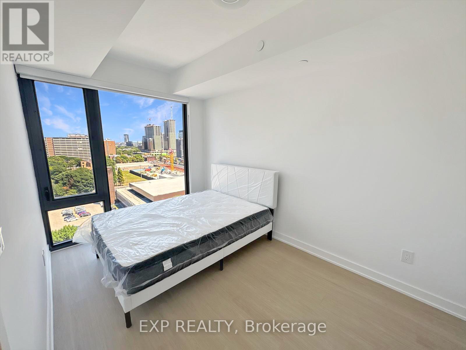 A bedroom with a large bed and a view of the city.
