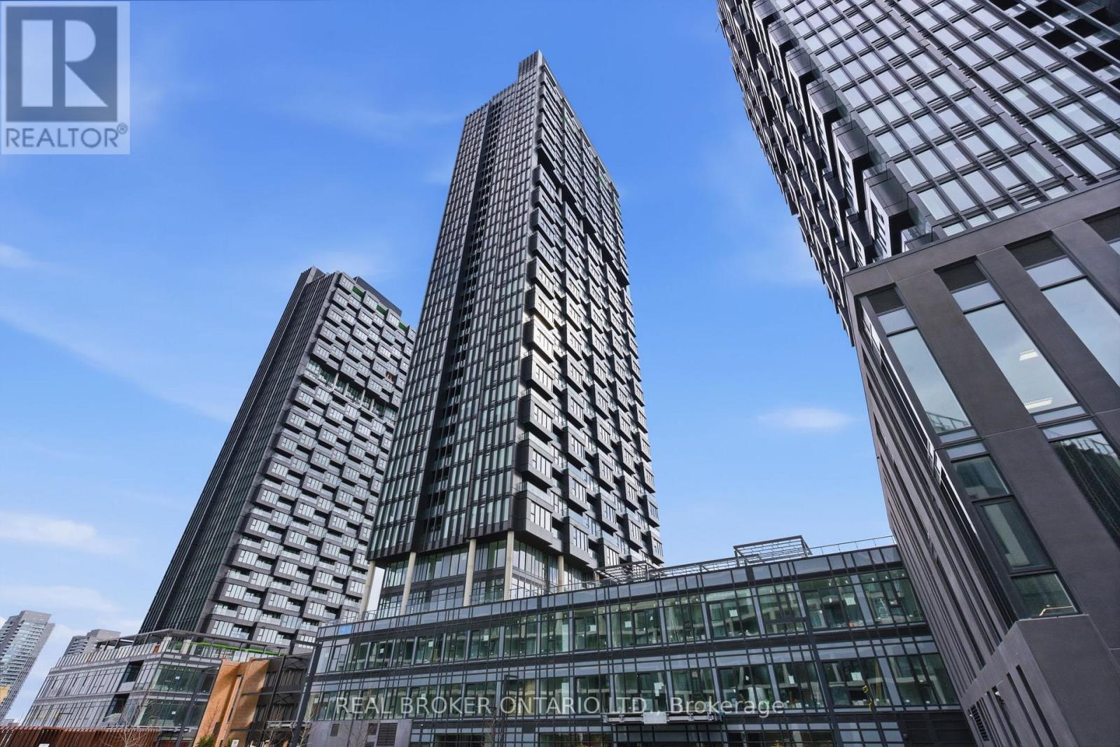 A tall building with the words "REAL BROKER ONTARIO" on its facade.