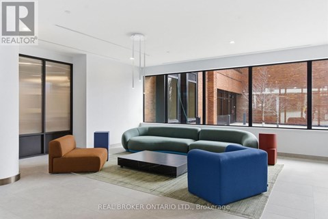 A living room with a blue sofa and orange chair.