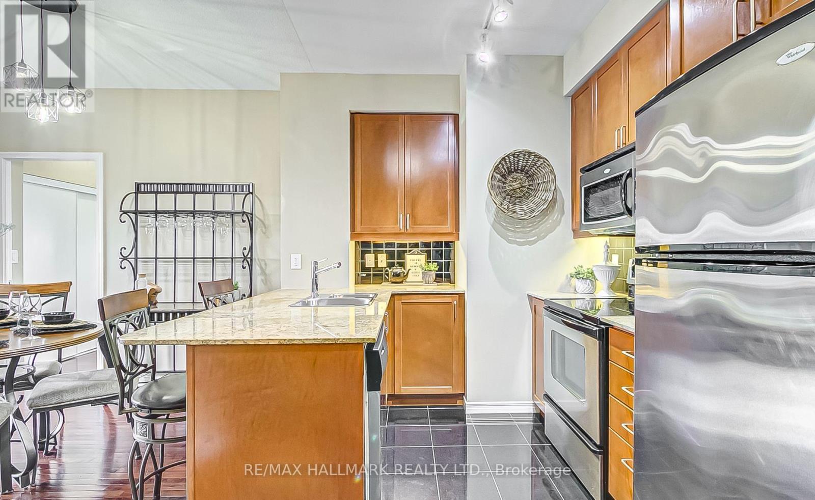 A kitchen with a white counter top and wooden cabinets.