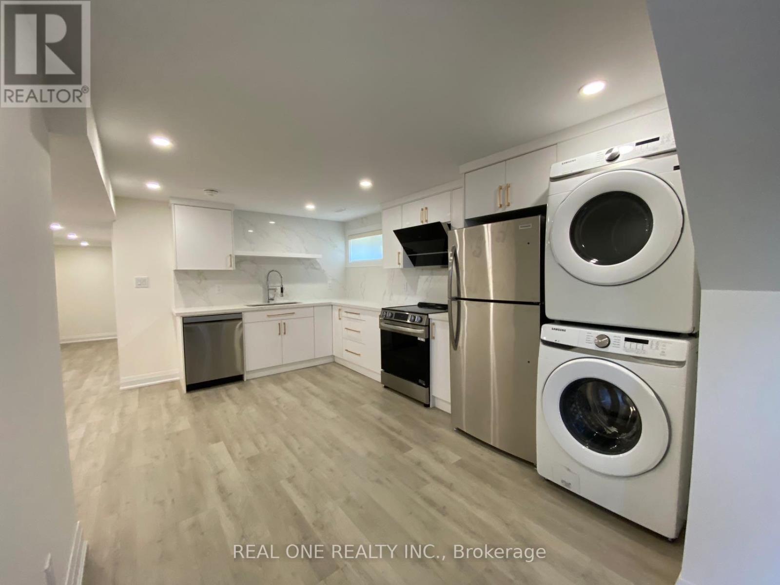 A laundry room with a washer and dryer stacked on top of each other.