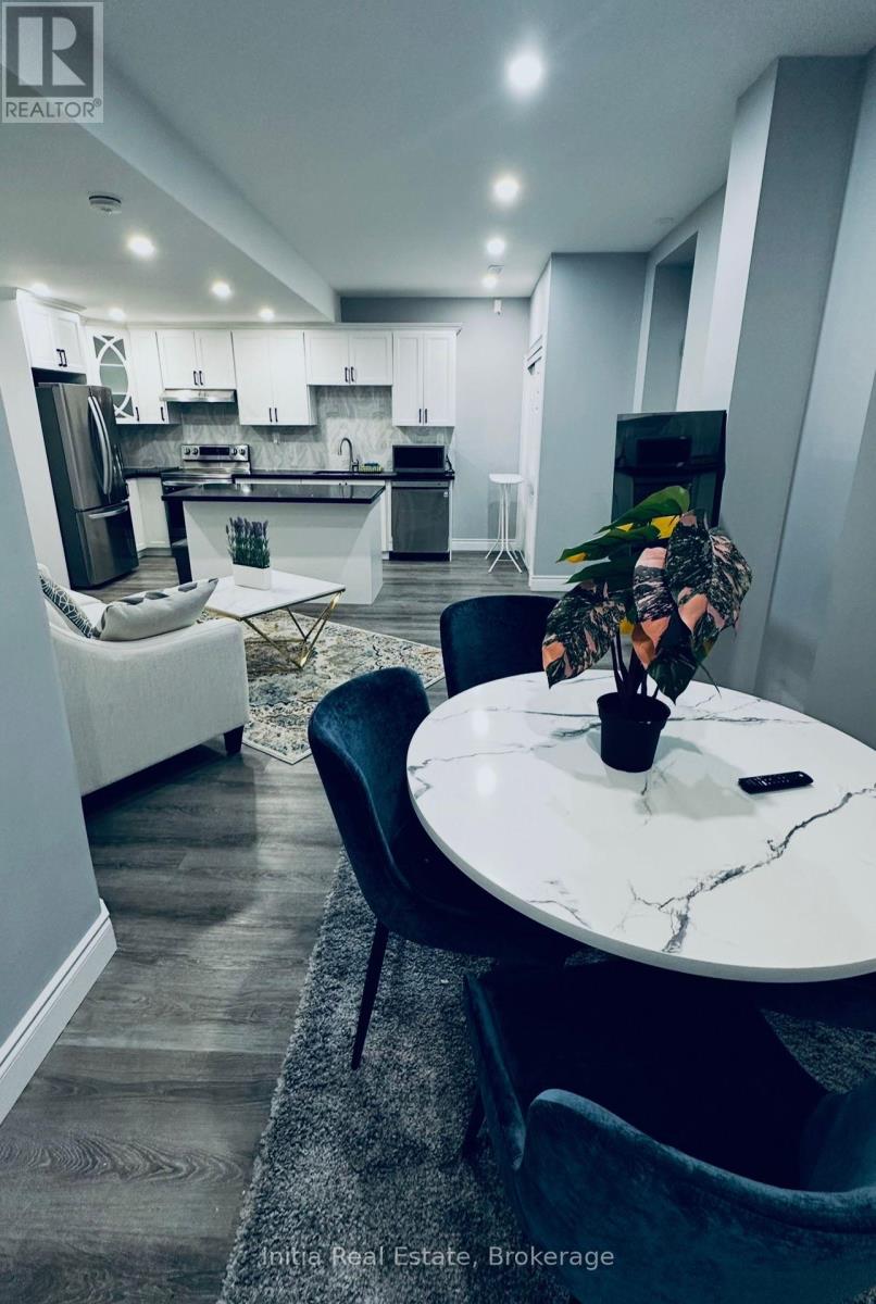 A modern kitchen with a dining table and chairs.