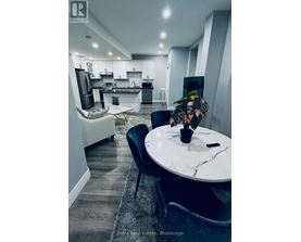 A modern kitchen with a dining table and chairs.