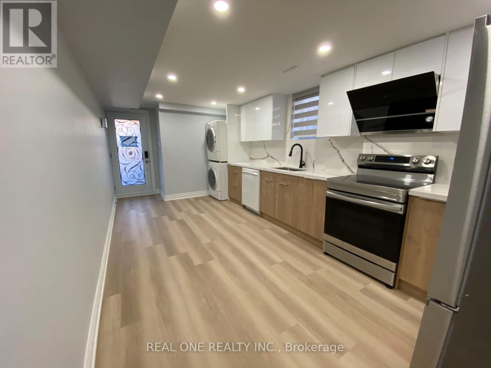 A kitchen with wooden floors and stainless steel appliances.