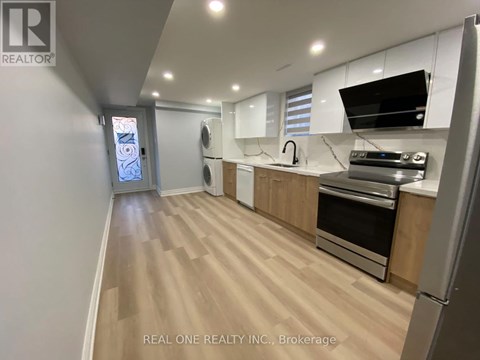 A kitchen with wooden floors and stainless steel appliances.