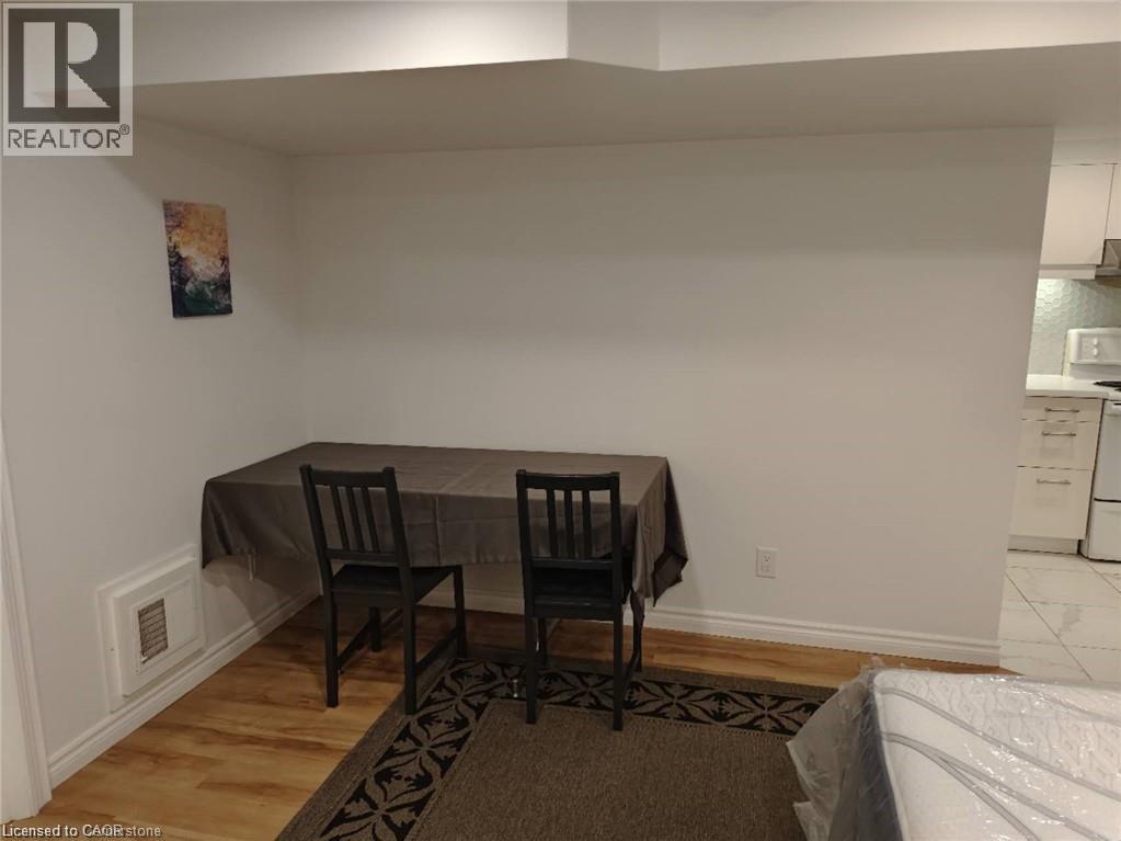 A dining room with a table and chairs.