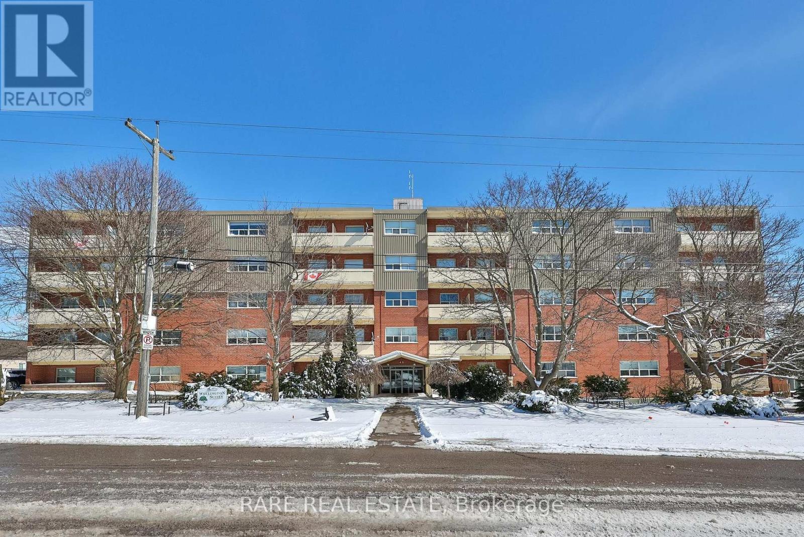 A large apartment complex with a clear blue sky above.