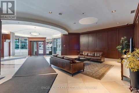 A large, well-lit living room with a long couch and a rug.