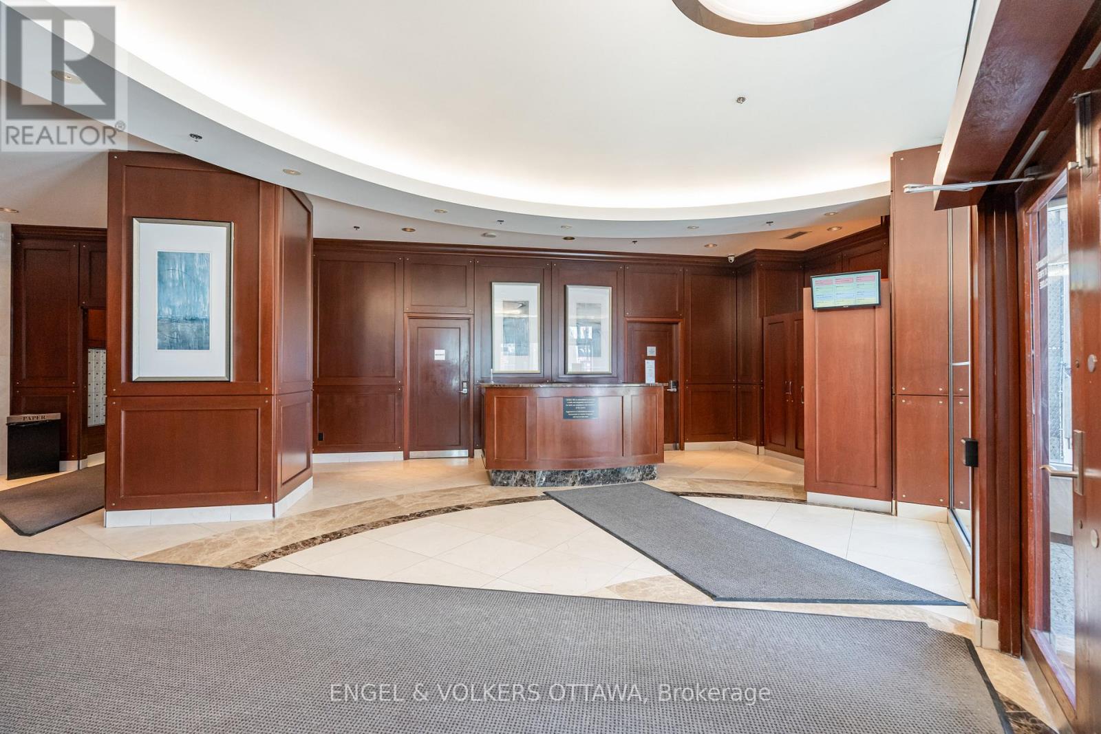 A brokerage office with wood paneling and a reception desk.