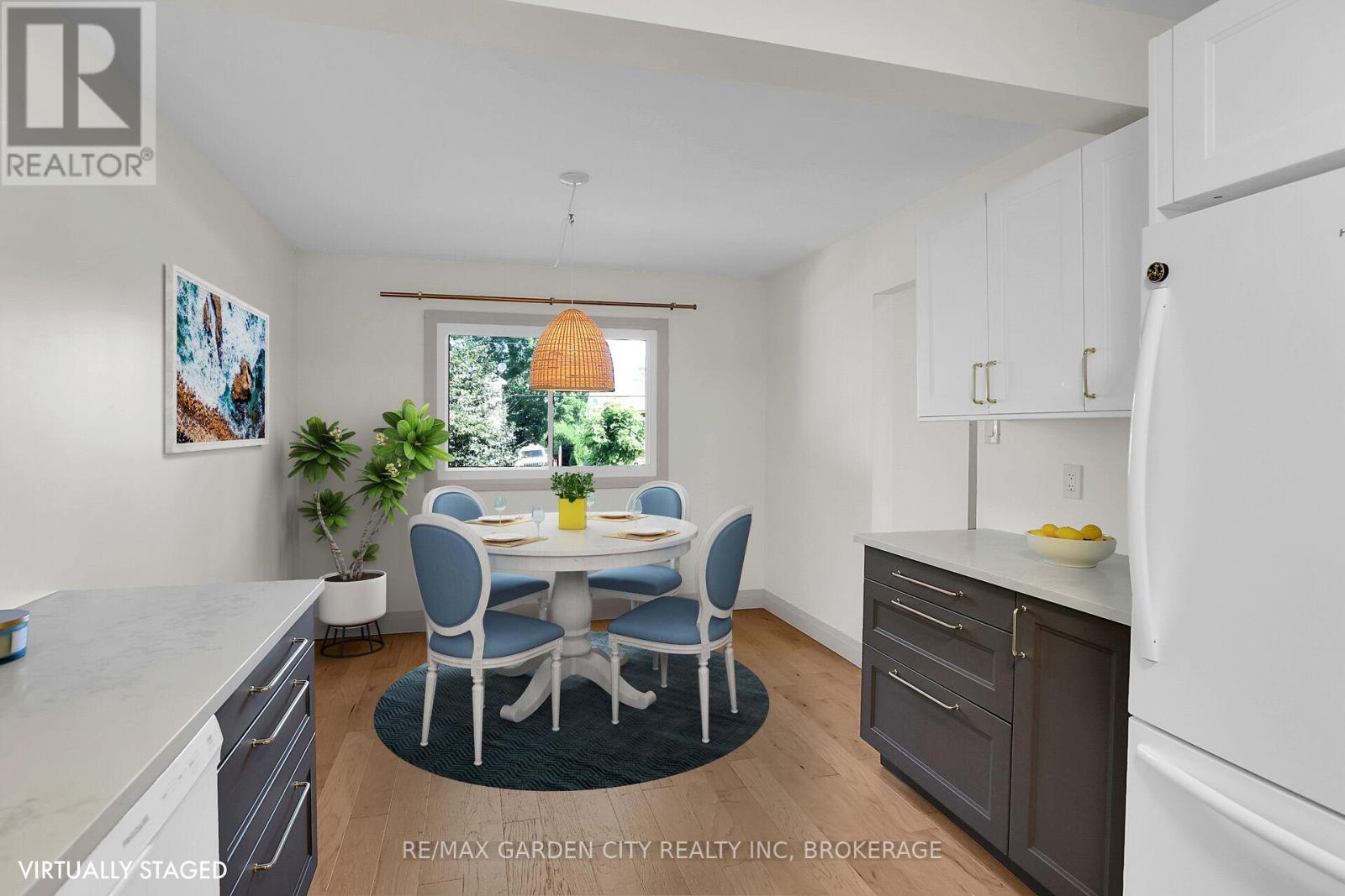 A dining room with a table set for four and a window letting in natural light.