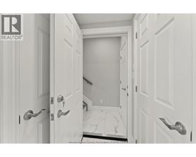A hallway with white doors and a marble floor.