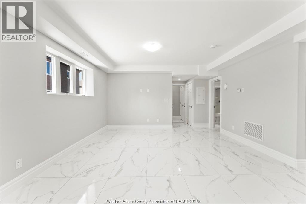 A spacious room with marble flooring and white walls.