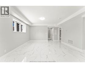 A spacious room with marble flooring and white walls.
