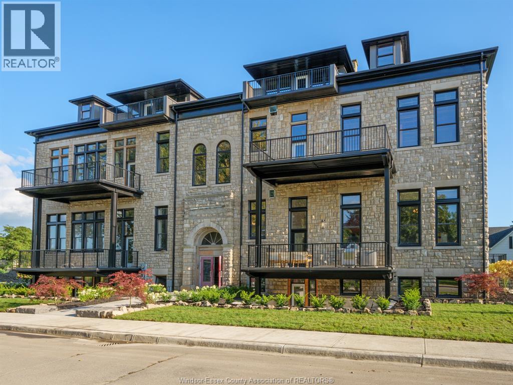 A large, multi-story building with balconies and a red door.