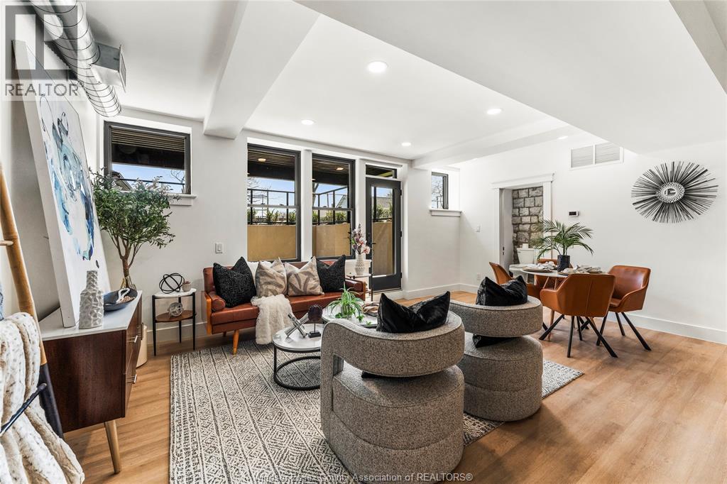 A living room with a grey rug and a brown chair.