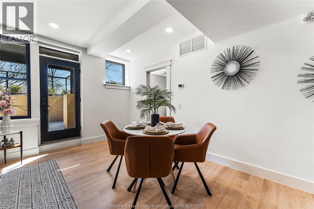 A dining room with a table set for six.