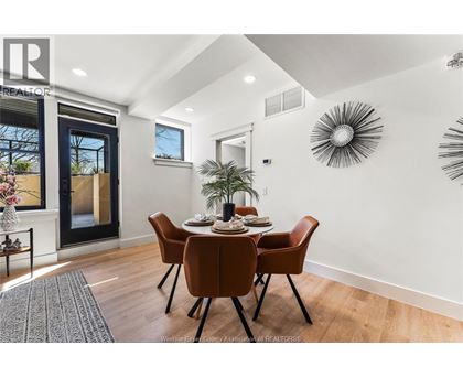 A dining room with a table set for six.