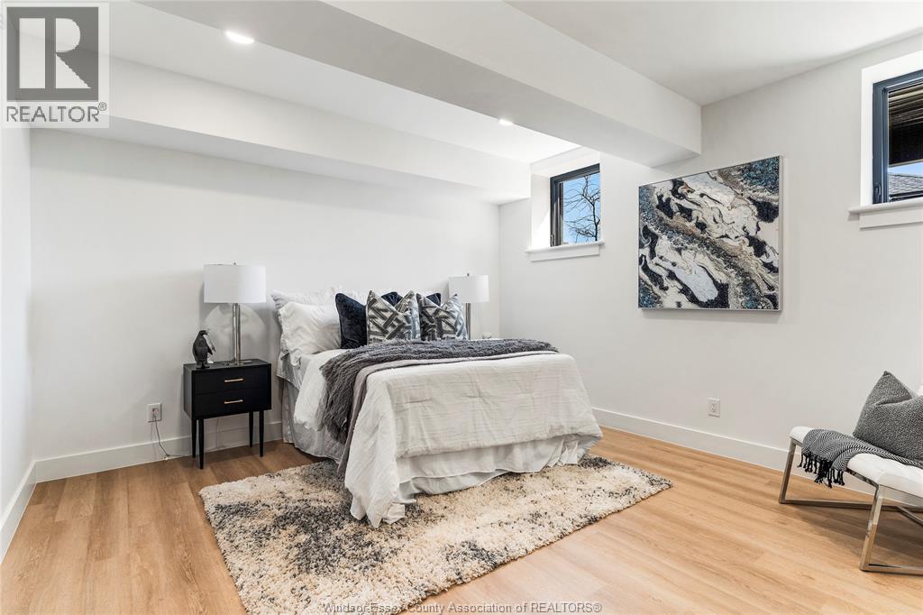 A bedroom with a bed, nightstand, and chair.