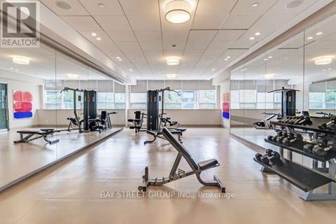 A gym with a variety of equipment including treadmills, weights, and exercise machines.