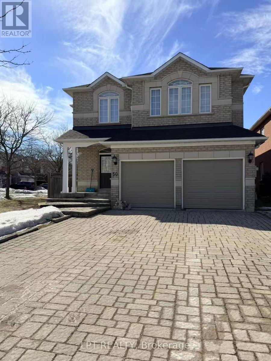 A house with a garage and a driveway in front.