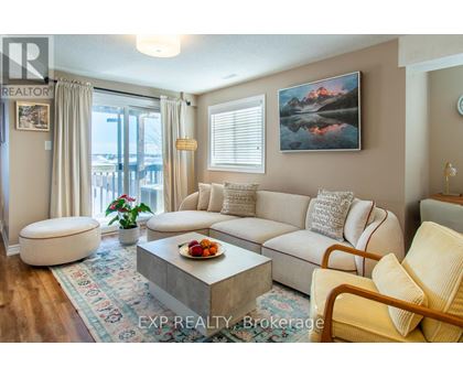 A living room with a large couch, a coffee table, and a painting on the wall.