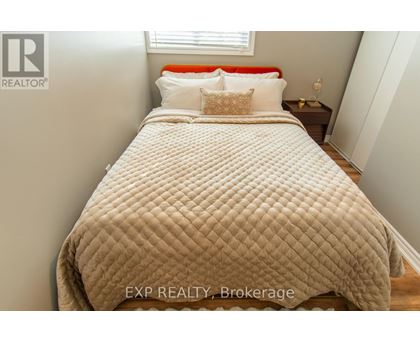A bed with a white comforter and pillows in a bedroom.